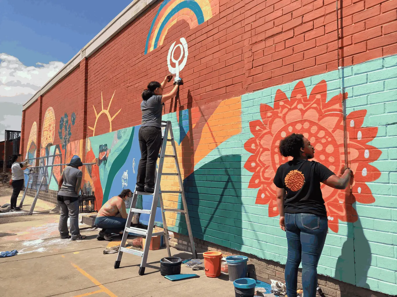An inspiring image of a community mural project led by CULTURAL EARTHQUAKE, demonstrating the organization's commitment to public art and community beautification.